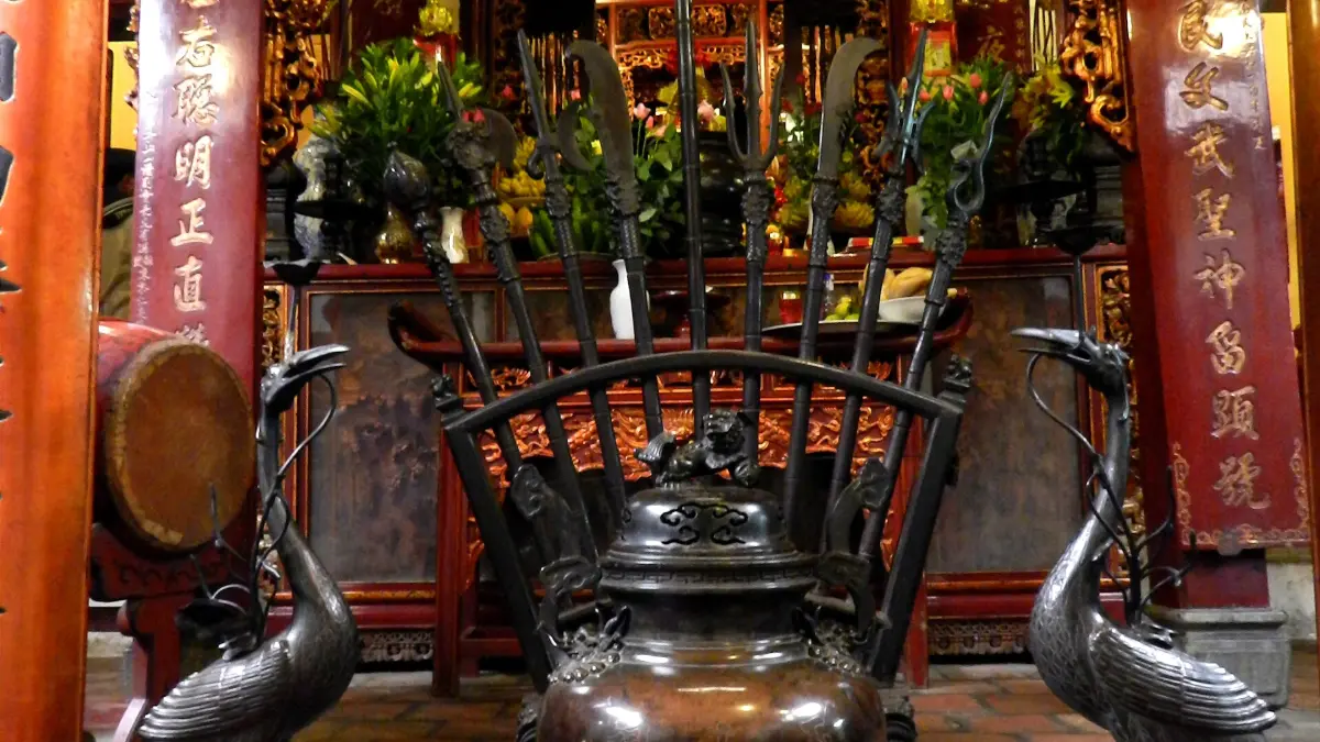 Altar in the Main Hall of Ngoc Son Temple, Hanoi Bronze incense burner and crane statues before the altar inside Ngoc Son Temple, Hanoi