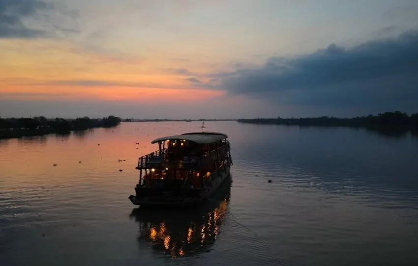 Bassac II wooden cruise boat at dawn on the Mekong Delta