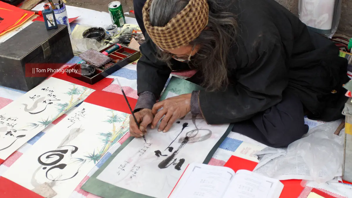 Calligraphy at the Temple of Literature Calligrapher writing Chinese characters at the Temple of Literature Hanoi