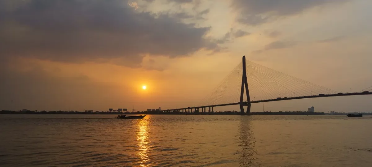 Sunset over the Hau River and Can Tho Bridge in Can Tho, the most popular base to stay in the Mekong Delta
