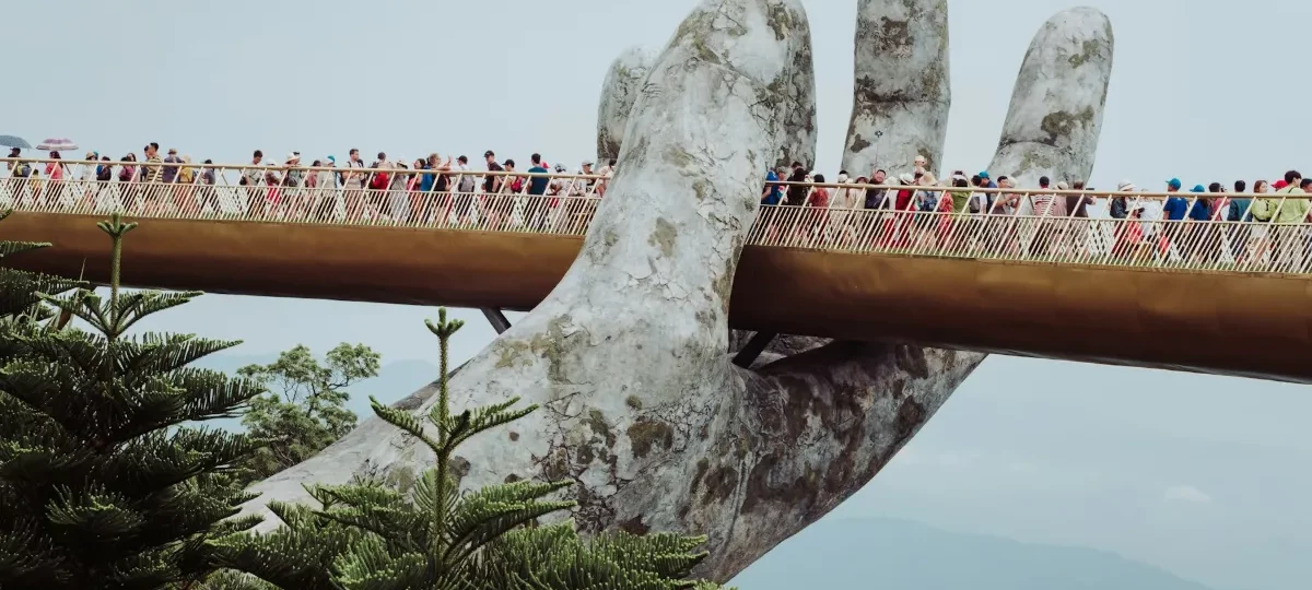Visitors walk across the Golden Bridge held up by giant stone hands at Ba Na Hills near Da Nang