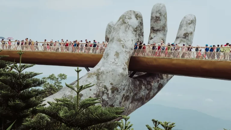 Visitors walk across the Golden Bridge held up by giant stone hands at Ba Na Hills near Da Nang