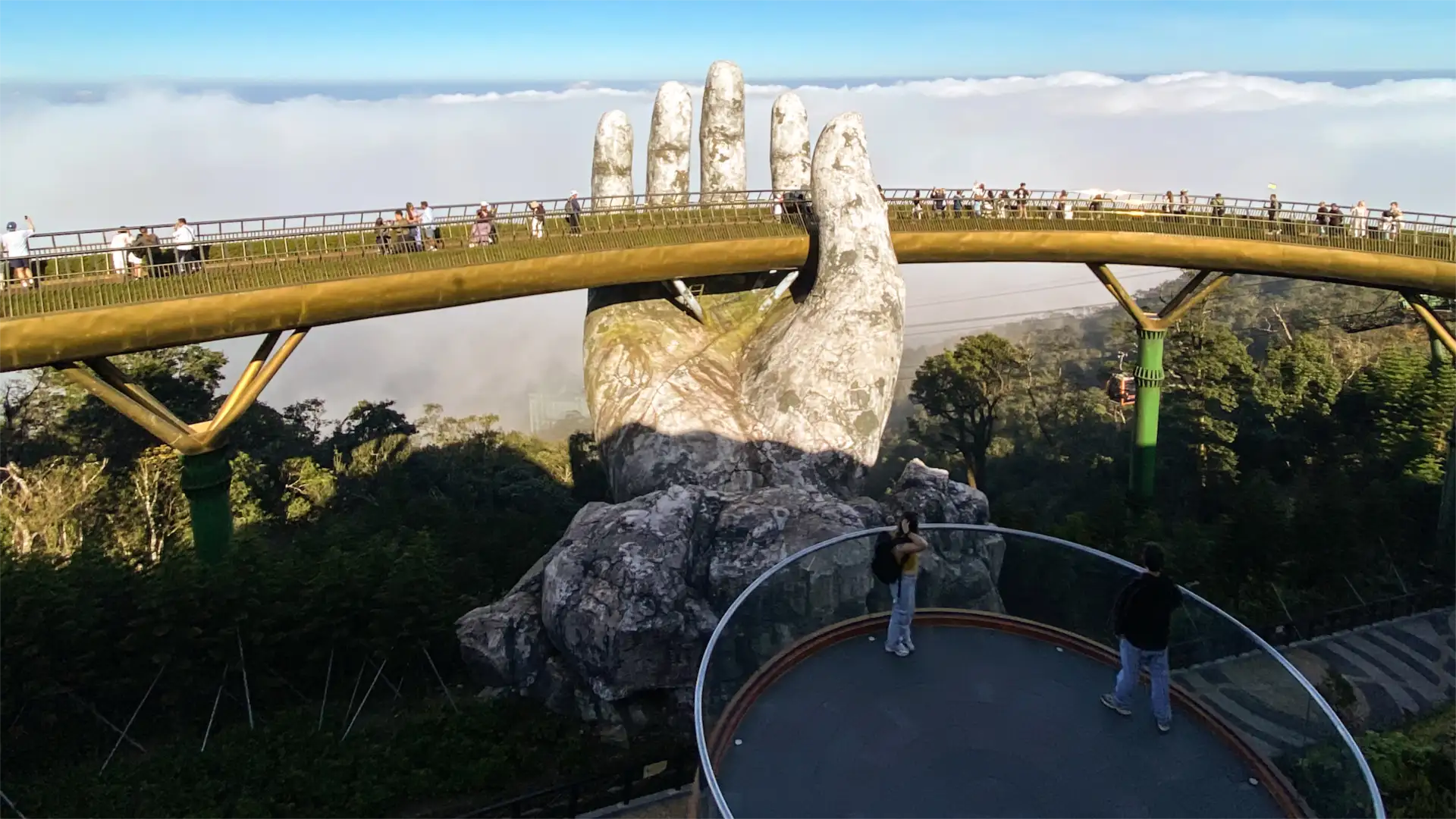 Golden Bridge held by giant stone hands above the clouds at Ba Na Hills, Da Nang