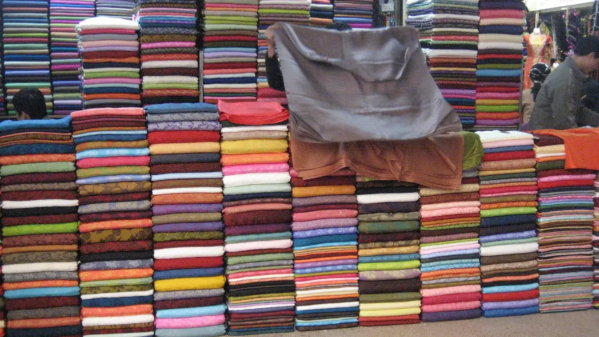 Fabric Stalls at Dong Xuan Market, Hanoi Colourful rolls of fabric stacked at a stall in Dong Xuan Market, Hanoi