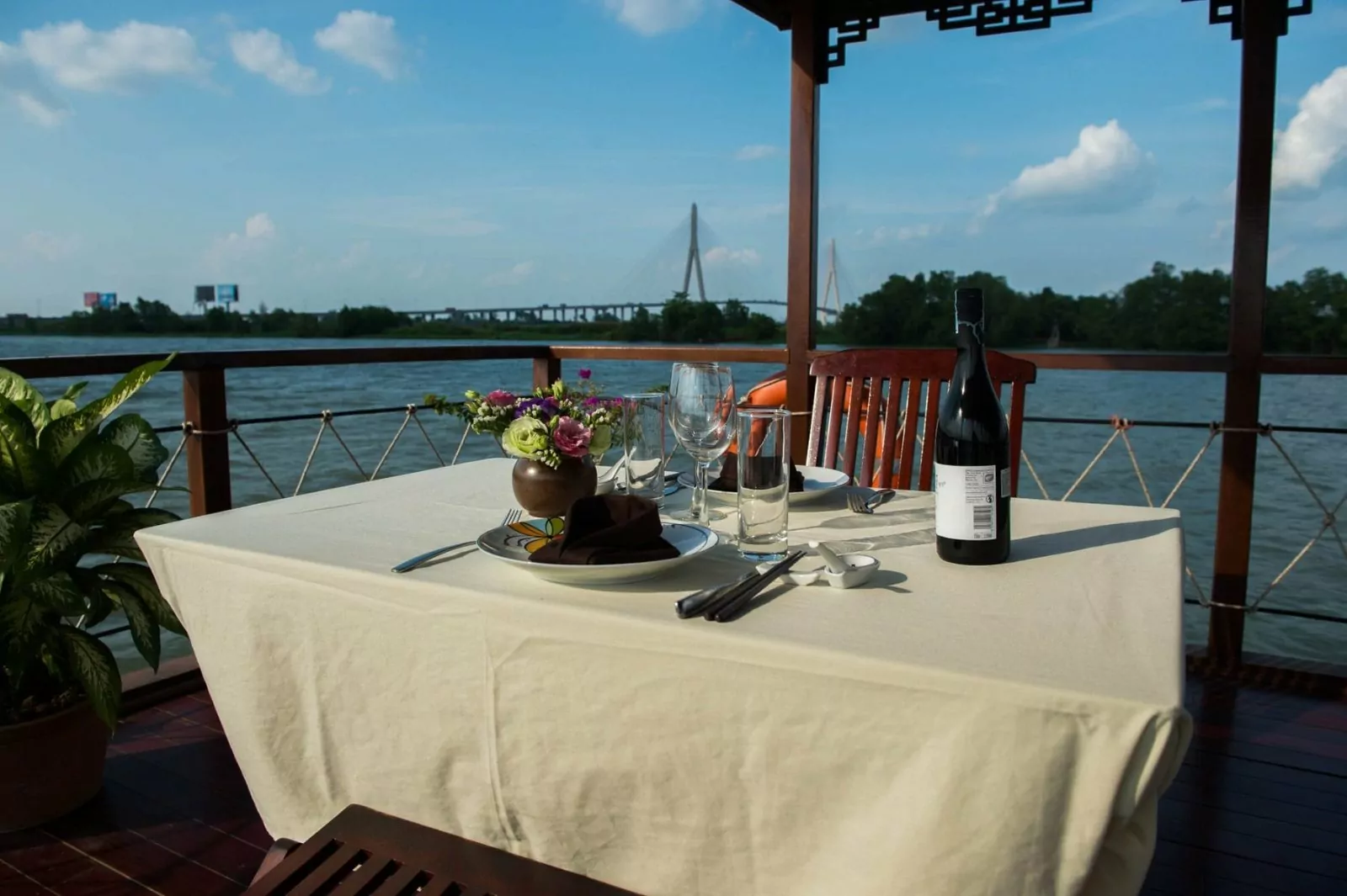 Private dining table with river view on the Dragon Eyes