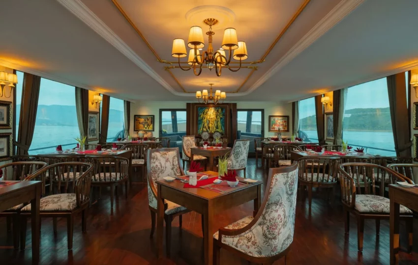 Dining room set for lunch with chandeliers and sea views on Emperor Cruises Legend
