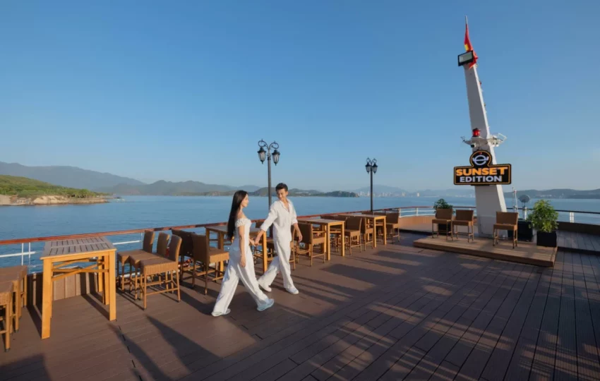 Couple walking on the wooden sundeck by the Sunset bar on Emperor Cruises Legend