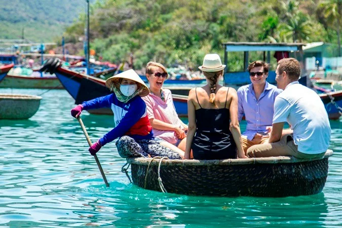 Guests riding a round bamboo basket boat around a fishing village in Nha Trang Bay