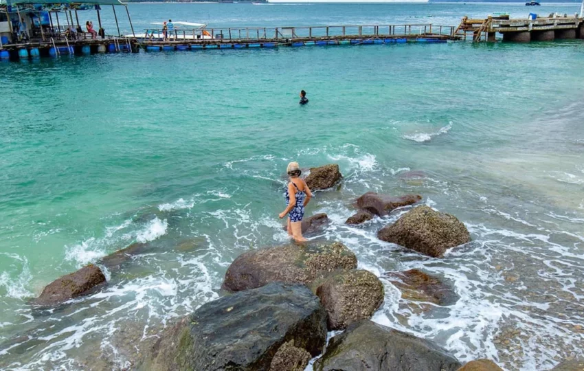 Swimming in clear turquoise water off the rocks on the Nha Trang Discovery Day Cruise