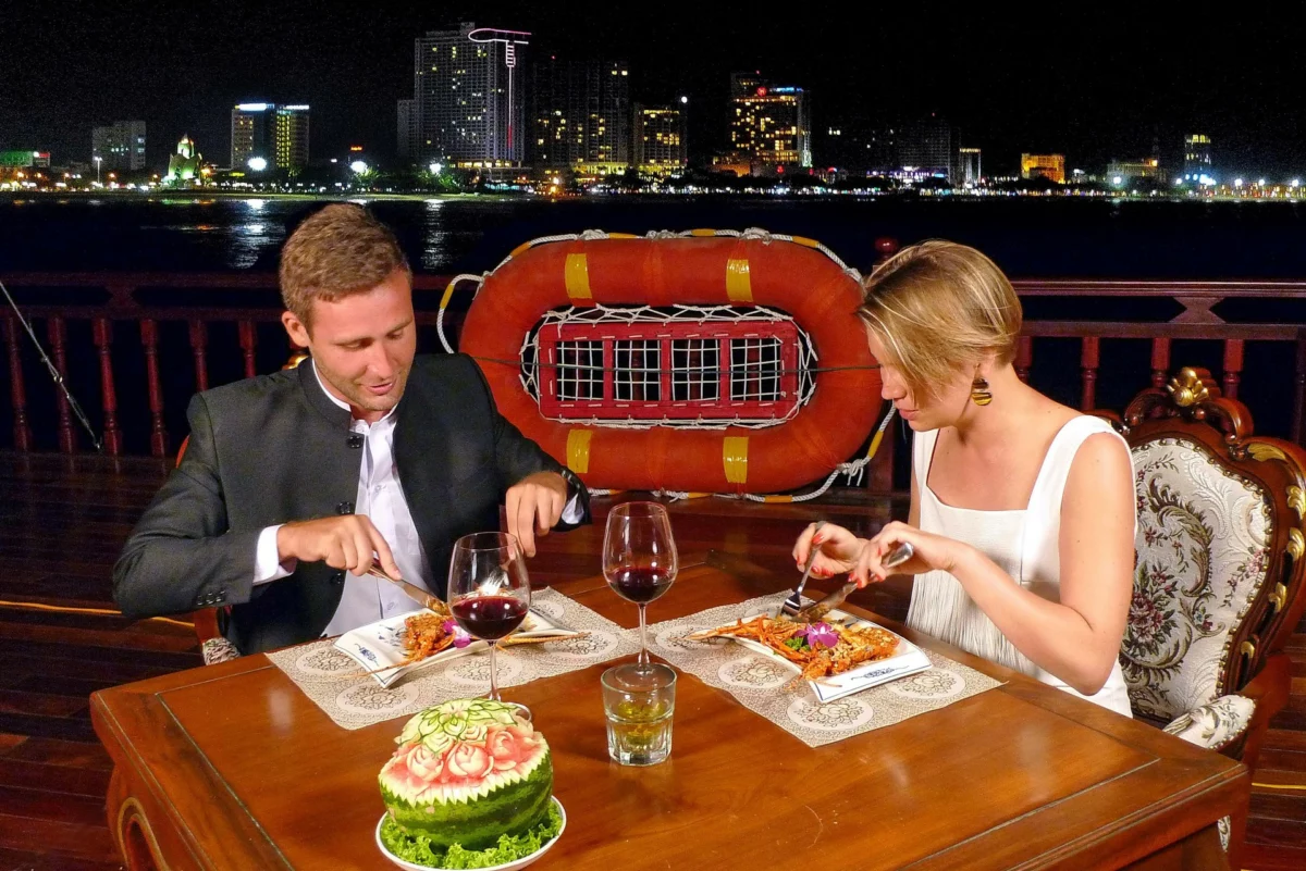 Couple enjoying the five-course seafood dinner on the Emperor Cruises sunset cruise