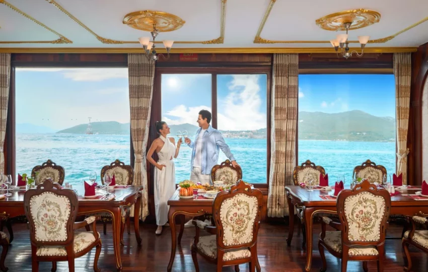 Crew serving drinks to guests in the restaurant of Emperor Cruises Origin