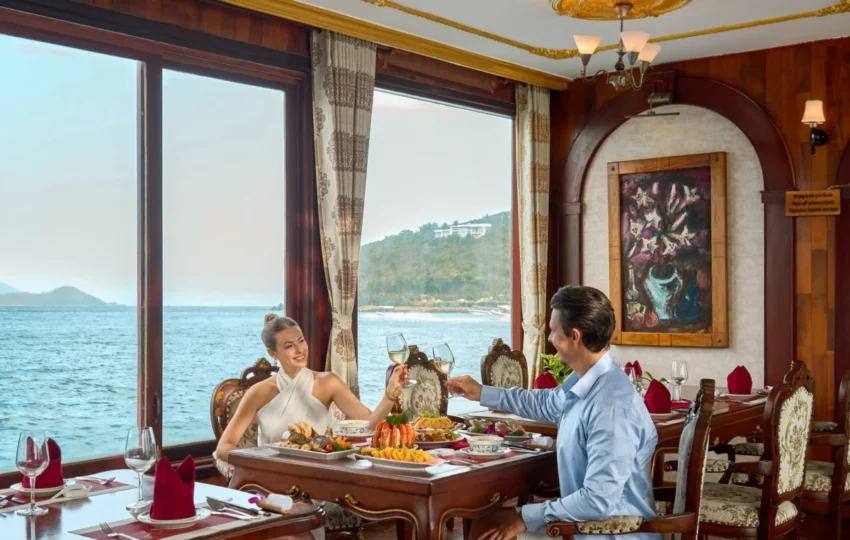 Couple served lunch at a window table in the Emperor Restaurant on Emperor Cruises Origin