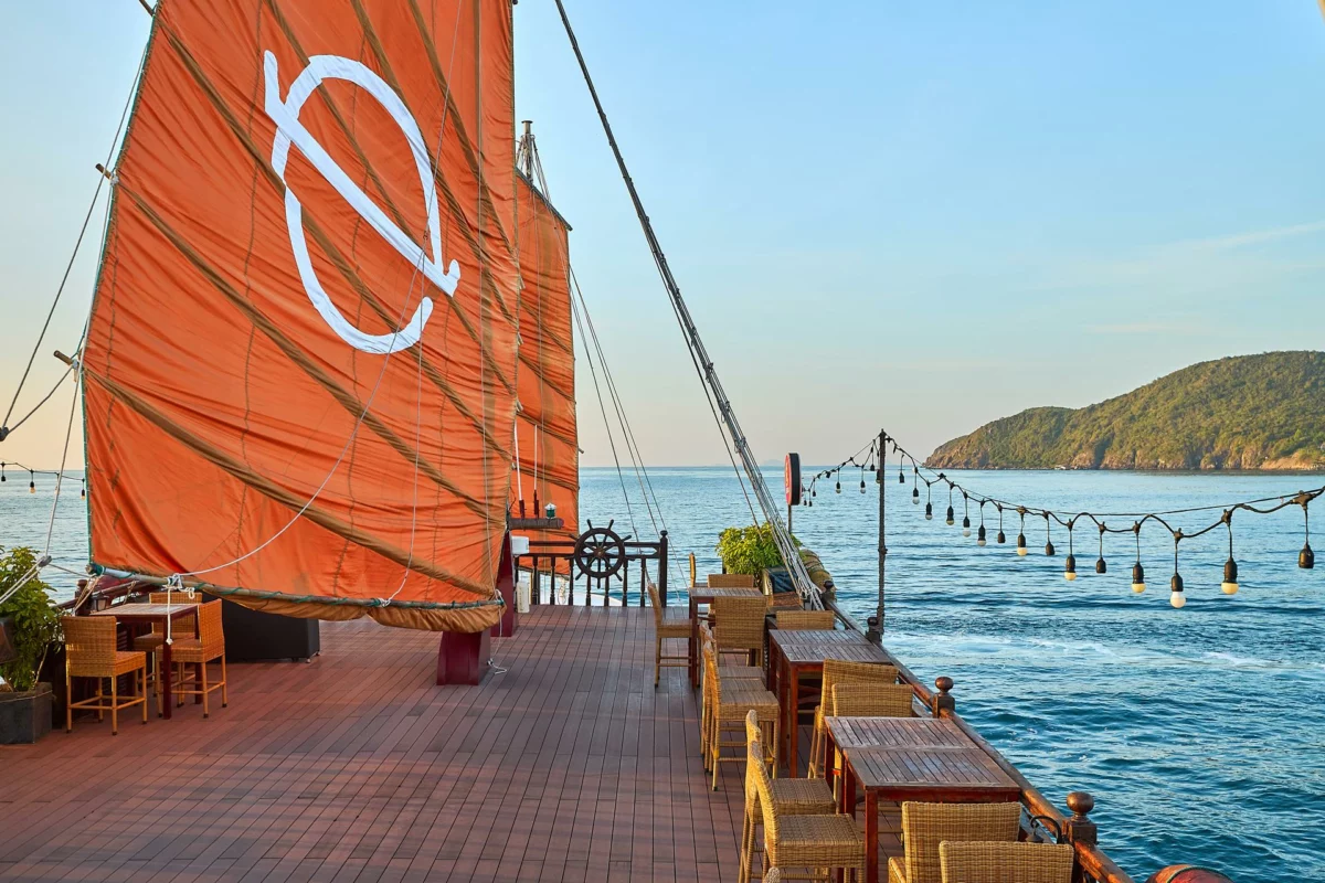 Sundeck under the orange sails of Emperor Cruises Origin with views of Nha Trang Bay