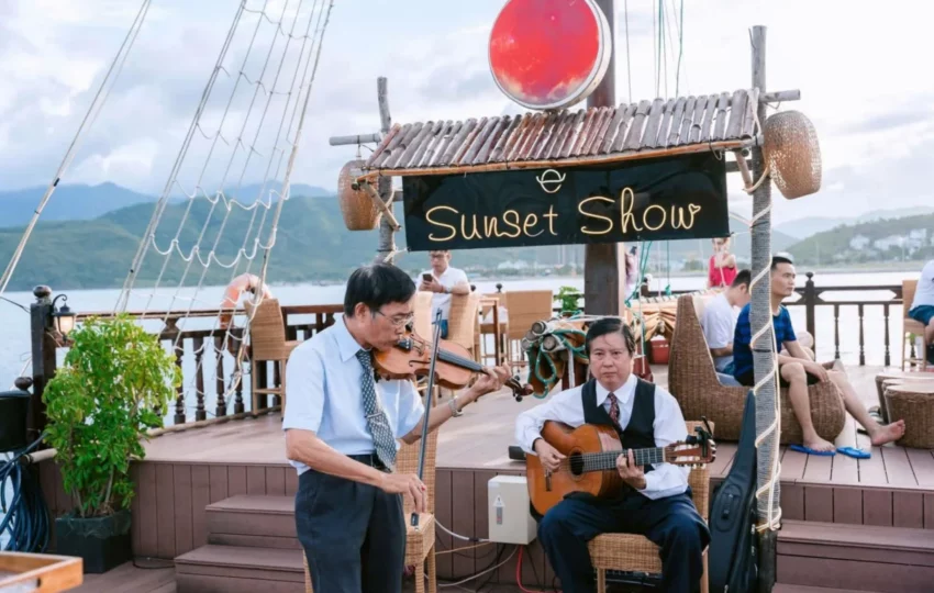 Violin and guitar duo performing at the Sunset Show stage on board Emperor Cruises