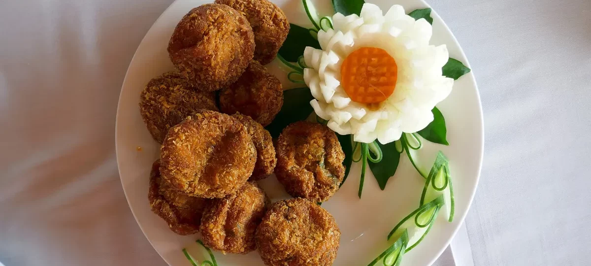 Plate of golden fried seafood cakes served aboard a Halong Bay cruise, a taste of Ha Long cuisine