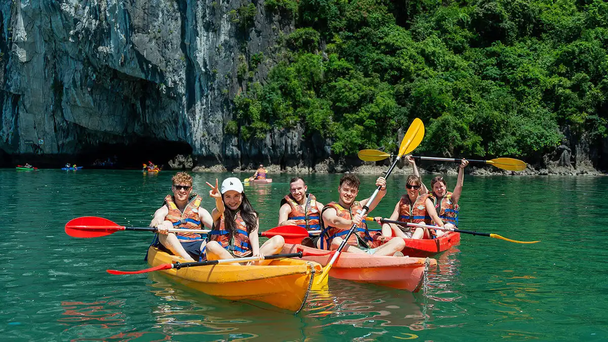Travellers kayaking near Luon Cave in Halong Bay on the Halong Heritage Luxury day cruise