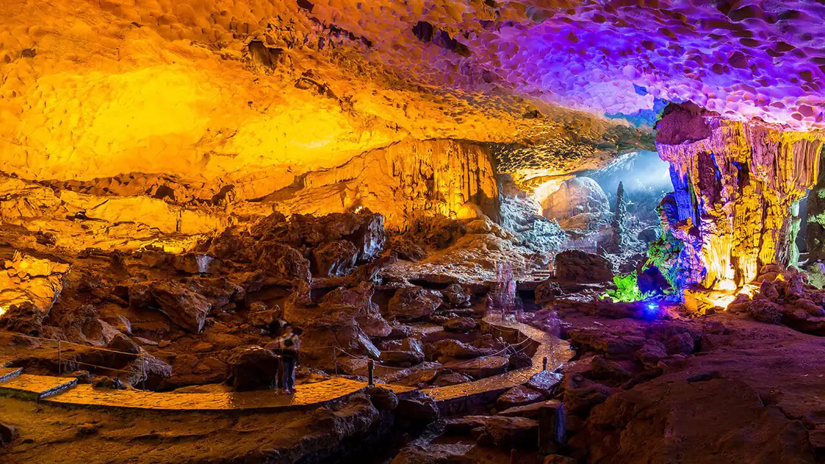 Illuminated rock formations inside Sung Sot (Surprise) Cave in Halong Bay