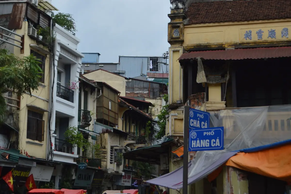 Shophouses and motorbikes on a street in the Hanoi Old Quarter