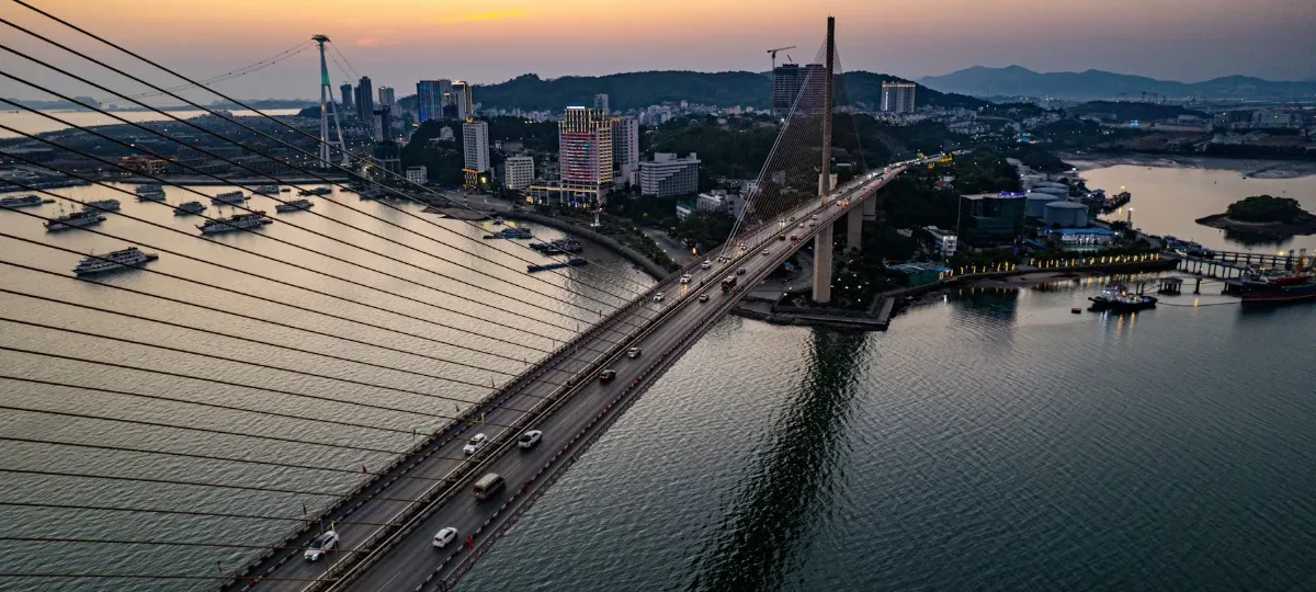 Aerial view of Bai Chay Bridge and Ha Long city at sunset, the gateway for travellers arriving from Hanoi