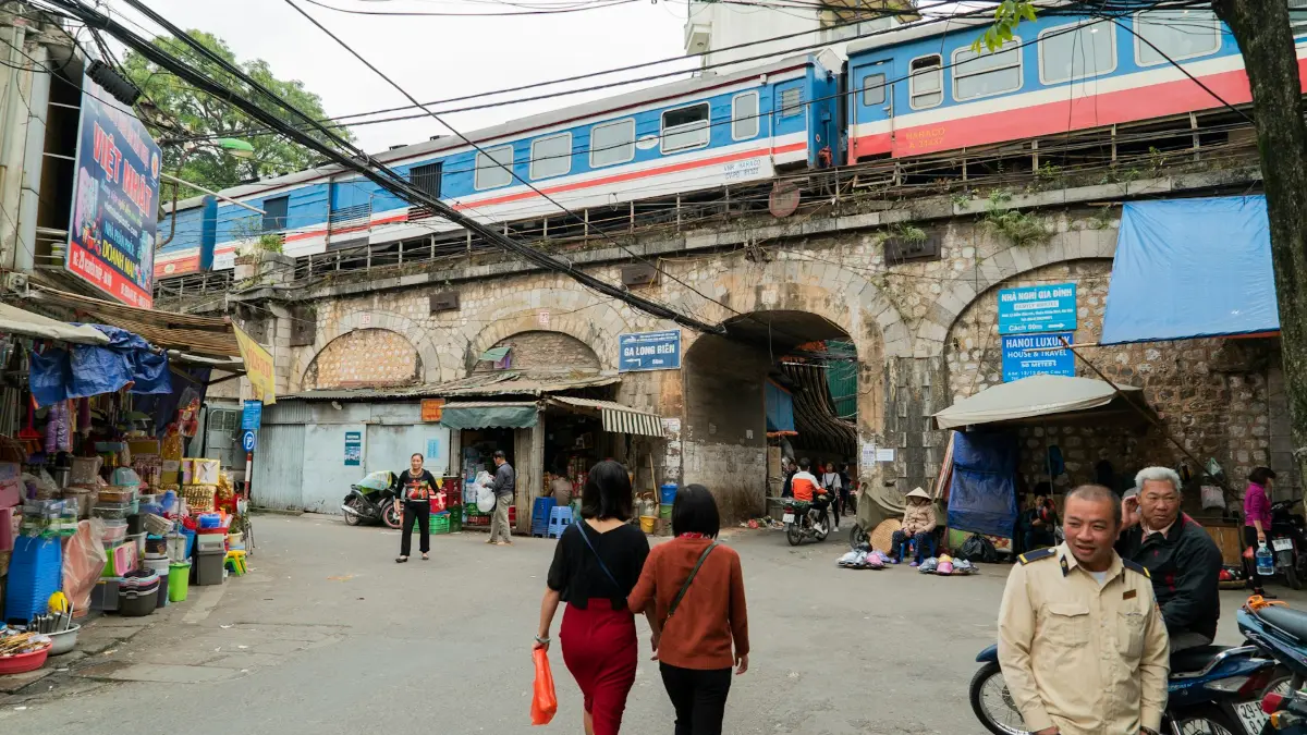 Hanoi Train Street – Railway Viaduct Arches on Phung Hung Street A passenger train crosses the colonial-era arched railway viaduct on Phung Hung Street, Hanoi
