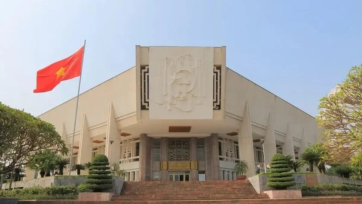 Facade of the Ho Chi Minh Museum in Hanoi with Vietnamese flag