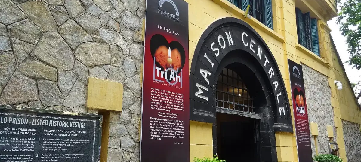 The yellow gate of Hoa Lo Prison with the words Maison Centrale, Hanoi