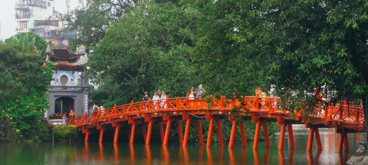The red Huc Bridge leading to Ngoc Son Temple on Hoan Kiem Lake in Hanoi