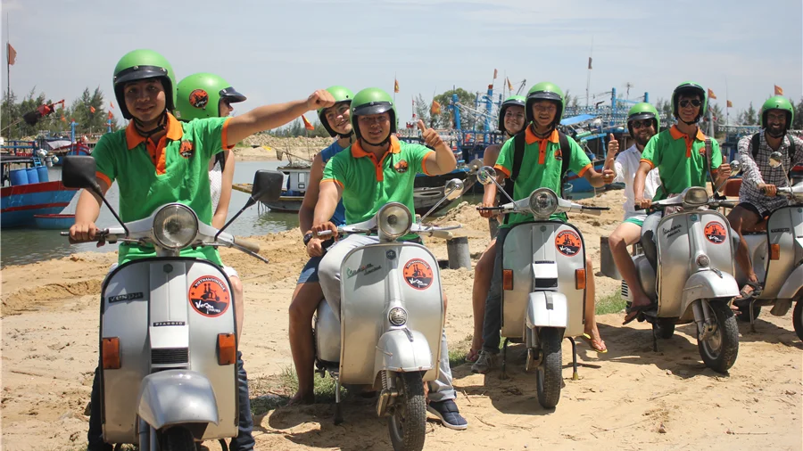 Vespa group at a fishing harbour
