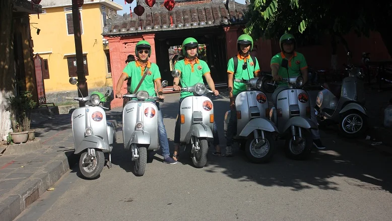 Vespas lined up on a street in Hoi An Old Town