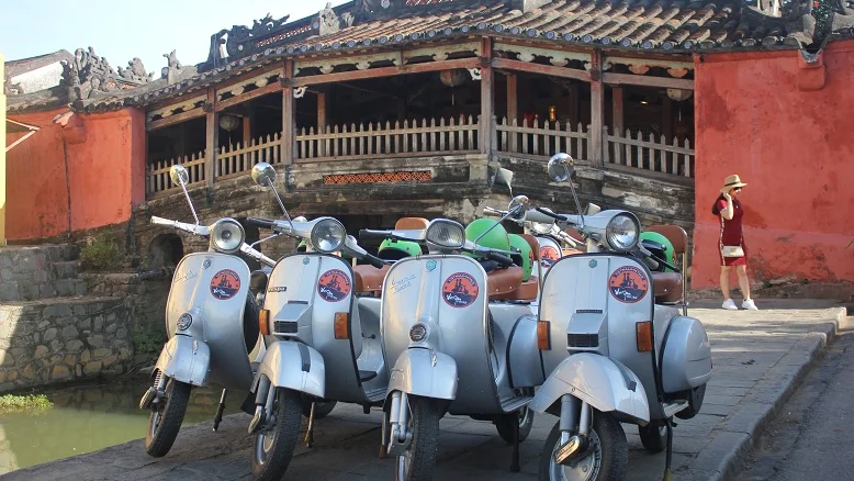 Vintage Vespas parked in front of the Japanese Covered Bridge, Hoi An
