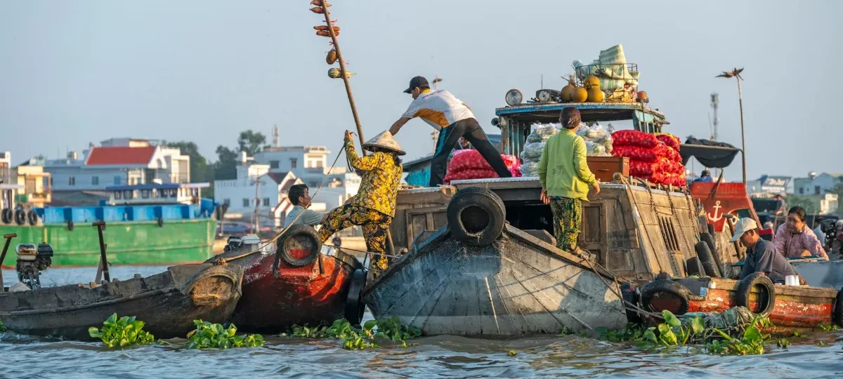 Wooden boats loaded with produce at Cai Rang floating market in Can Tho, the classic way to get around the Mekong Delta