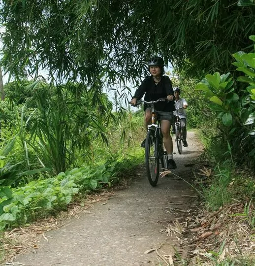 Cycling along green paths under bamboo near Can Tho