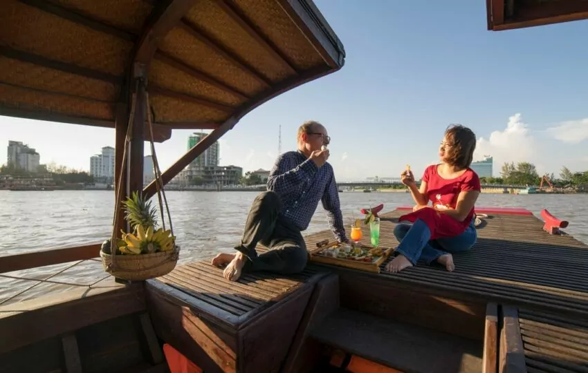 Mystic sampan departing for a sunset cruise on the Mekong