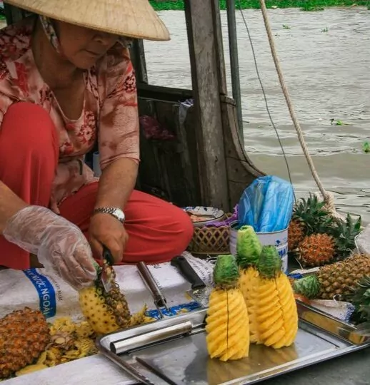Visiting a pineapple seller’s boat at the Cai Rang floating market