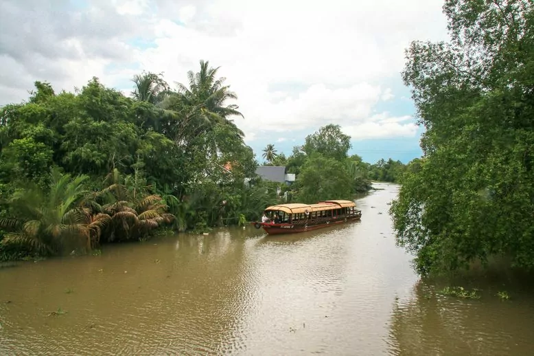 A Mystic sampan heading into smaller rivers and green countryside
