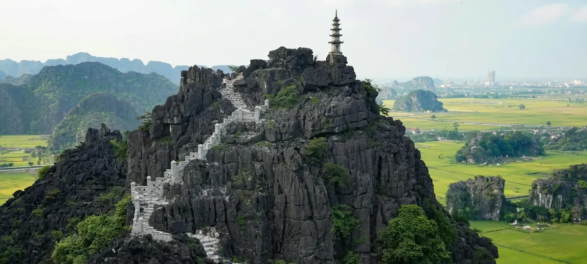 Stone steps winding up to the pagoda on top of the Hang Mua viewpoint above the rice fields of Ninh Binh