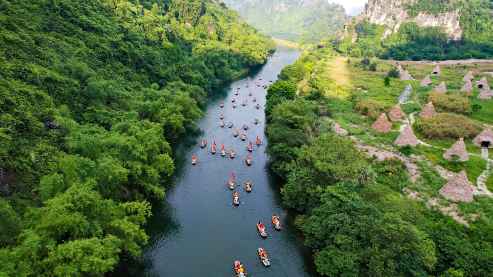 Aerial view of rowing boats on the river between limestone karsts in Ninh Binh, Vietnam