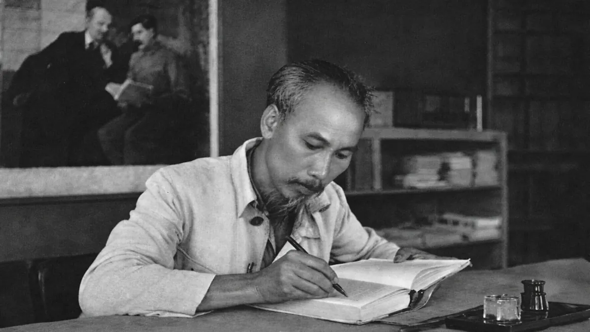 Historic photo of President Ho Chi Minh writing at his desk