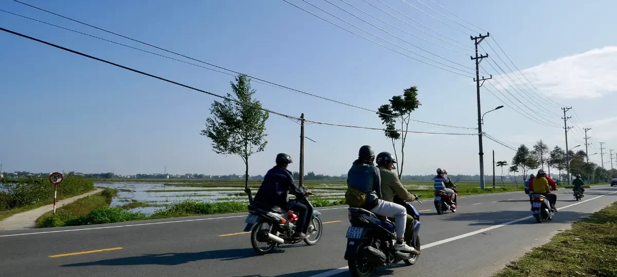 Motorbikes on the country road through Tra Que village near Hoi An