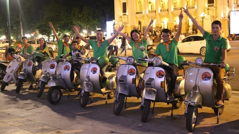 Vespa group at night in central Saigon