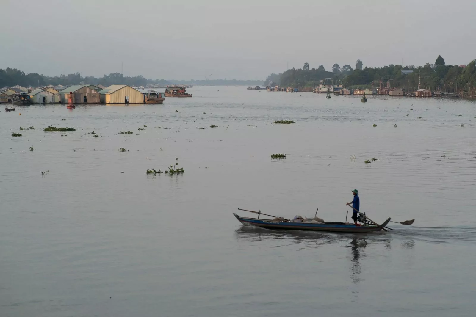 Local sampan boat on the Mekong River during a Victoria Mekong cruise excursion