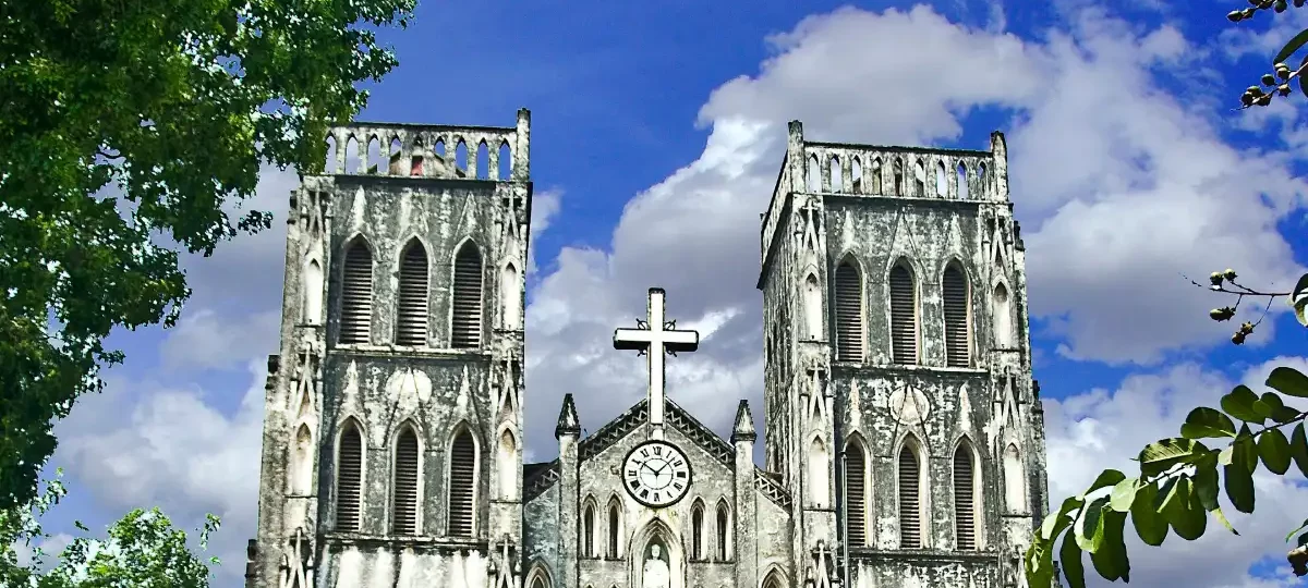 St Joseph's Cathedral Hanoi neo-Gothic facade and twin bell towers under a blue sky