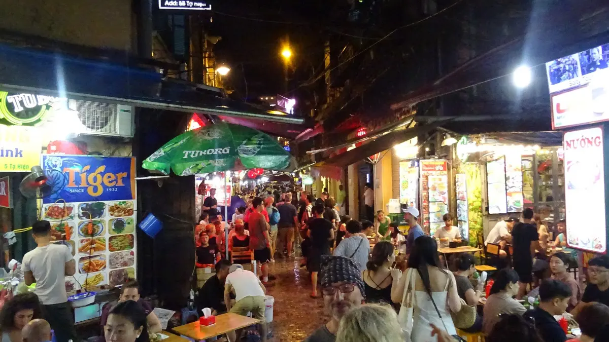 Ta Hien Beer Street at Night, Hanoi Old Quarter Crowds drinking beer on low stools along Ta Hien street at night in the Hanoi Old Quarter