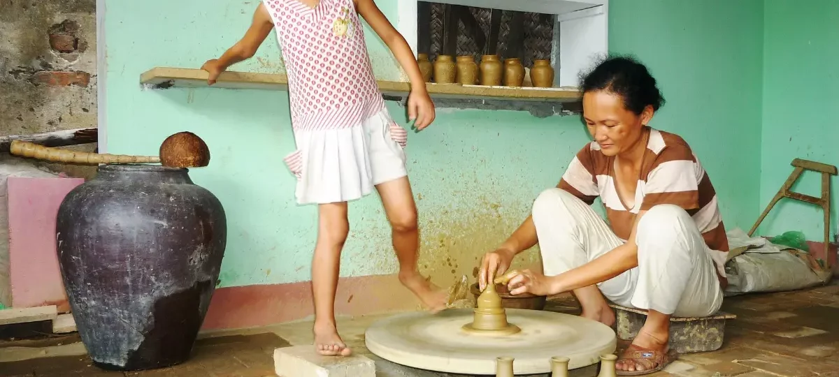 Potter shaping clay at Thanh Ha pottery village, Hoi An