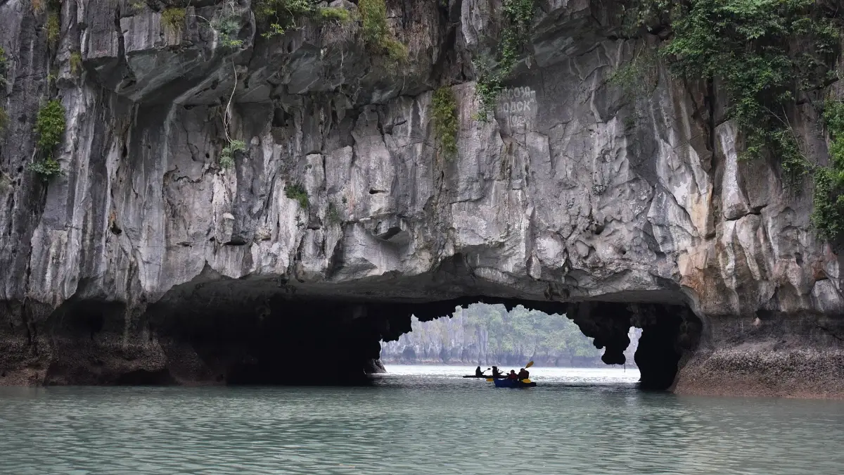Boat Through Luon Cave, Halong Bay Bamboo boat passing through Luon Cave into the lagoon, Halong Bay