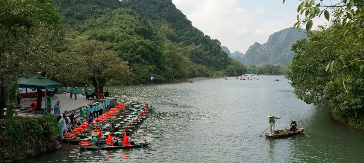 Rowing boats gliding between limestone karsts on the river at Trang An, Ninh Binh