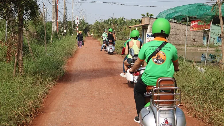Red dirt road by Vespa near Saigon