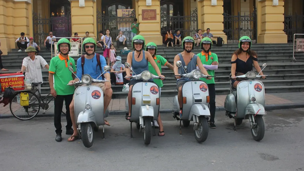 Vespa group at a colonial building in Hanoi