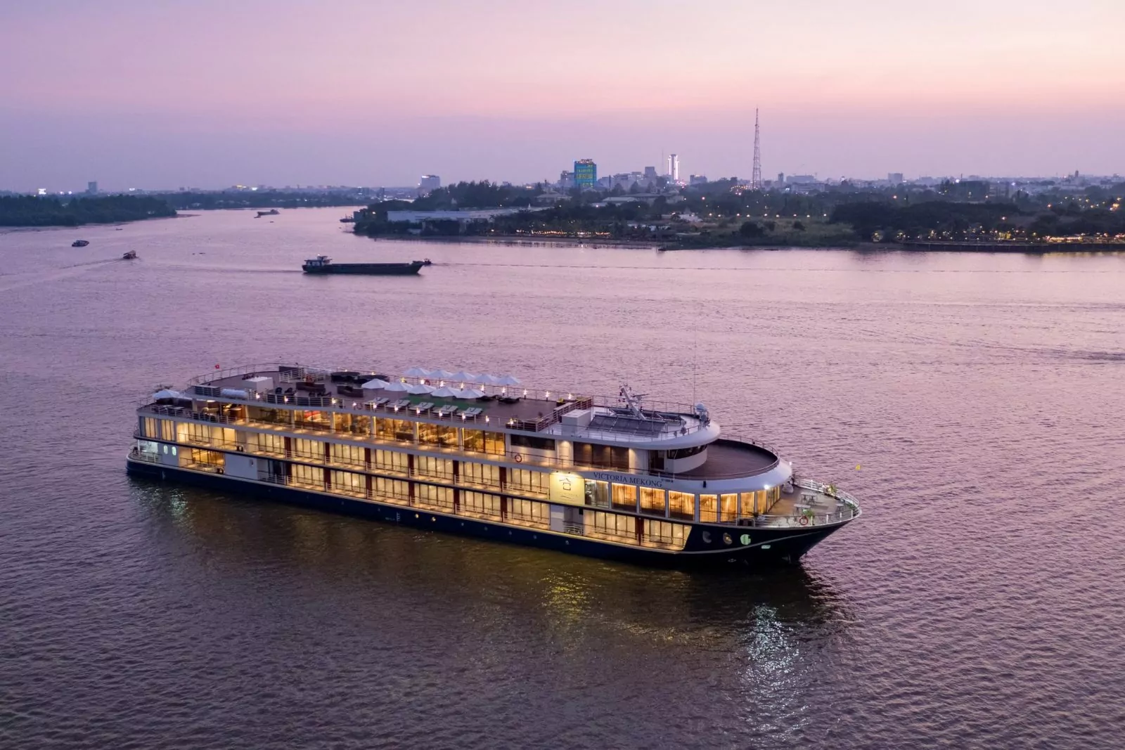 Victoria Mekong cruise ship sailing on the Mekong River at dusk