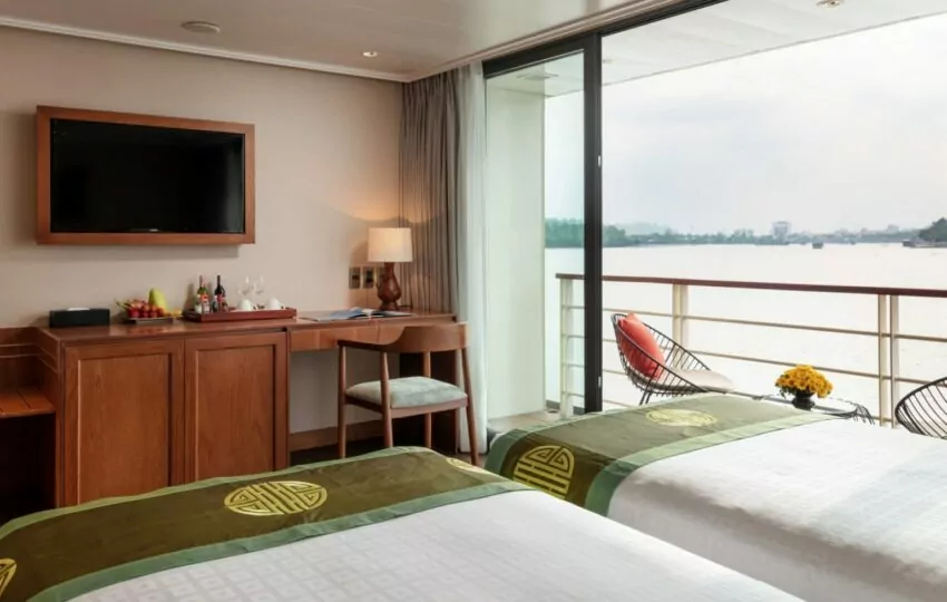 Writing desk, TV and private balcony door in a Victoria Mekong Deluxe cabin